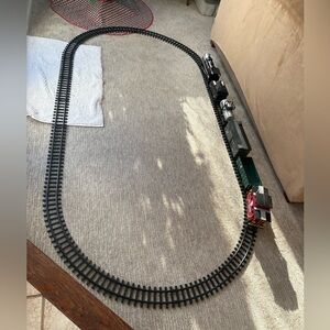 Remote control train set with large track, 8 cars, and signs